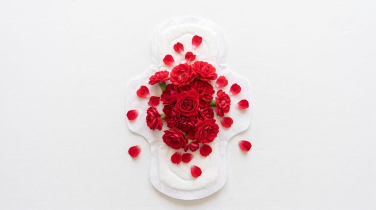 Compresa sobre fondo blanco cubierta de flores y pétalos rojos